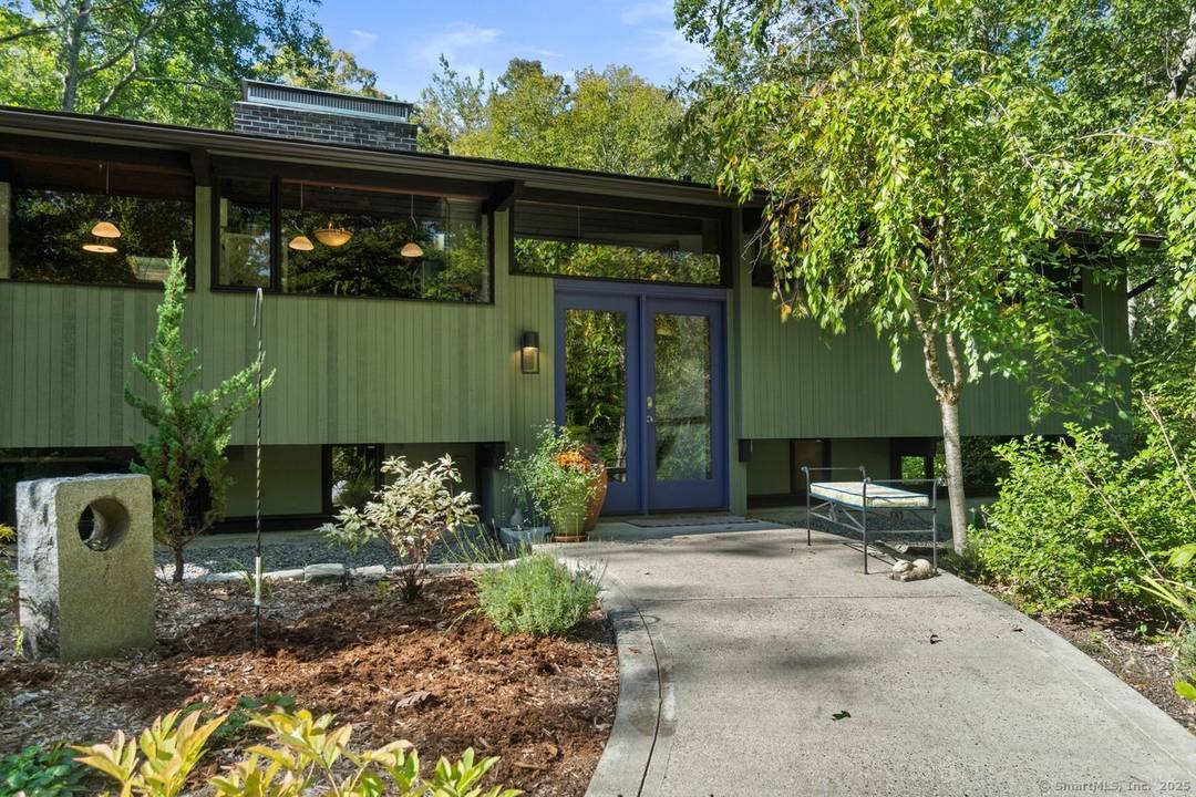 Set on 2 private acres in scenic East Haddam, this custom Acorn Deck Home offers a peaceful retreat surrounded by native gardens and a tranquil water feature.
