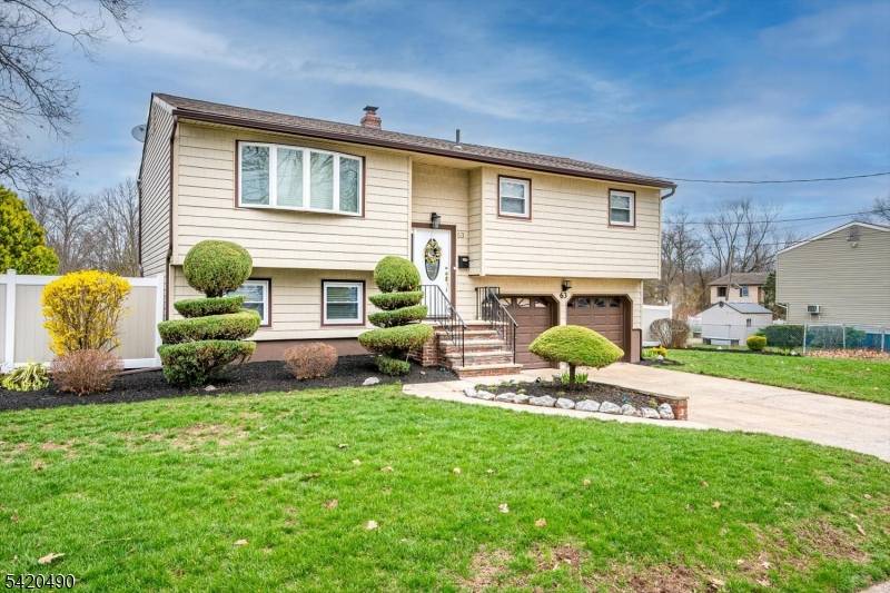 Welcome to this beautifully maintained bi level home situated on a large, flat corner lot with professional landscaping and exceptional curb appeal.
