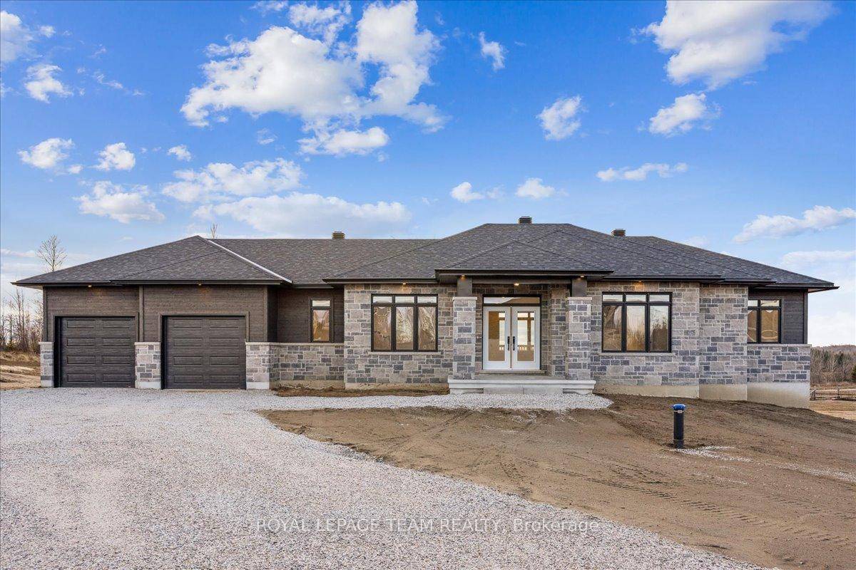 Located in the second phase of Hogan Heights, this thoughtfully designed bungalow blends country charm with modern convenience.