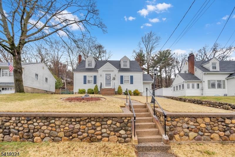 Welcome home to this move in ready Cape Cod tucked on one of Hawthorne's most sought after streets.