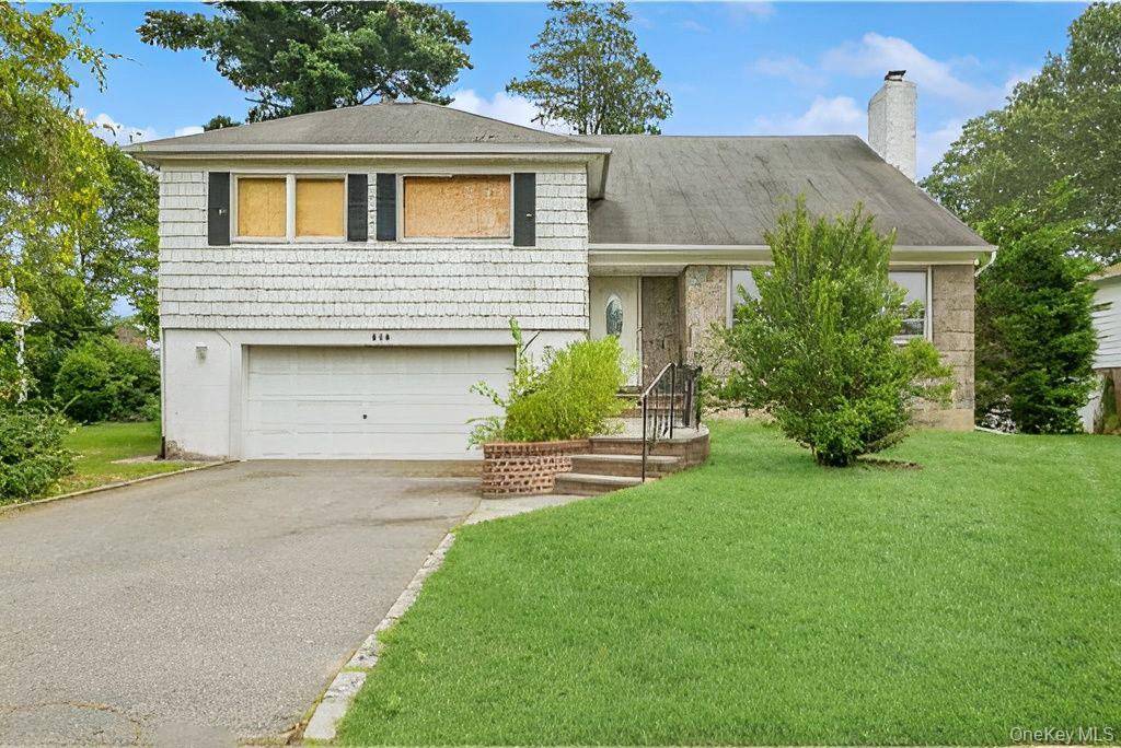 Split home in Sherwood Gardens section of Westbury with 2, 371 sq ft on a 7, 800 sq ft lot.