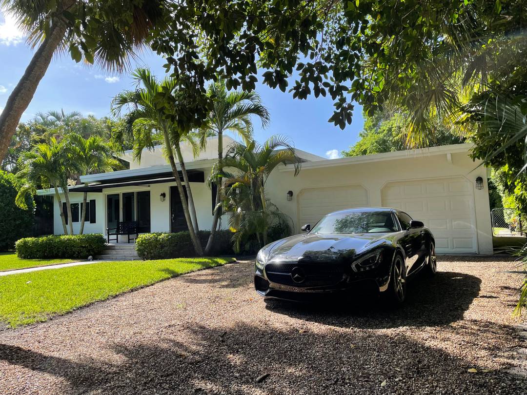 Tucked away upon a rare, lushly landscaped oversized 15, 500 sq ft private lot on Hypoluxo Island sits this Mid Century Modern gem.