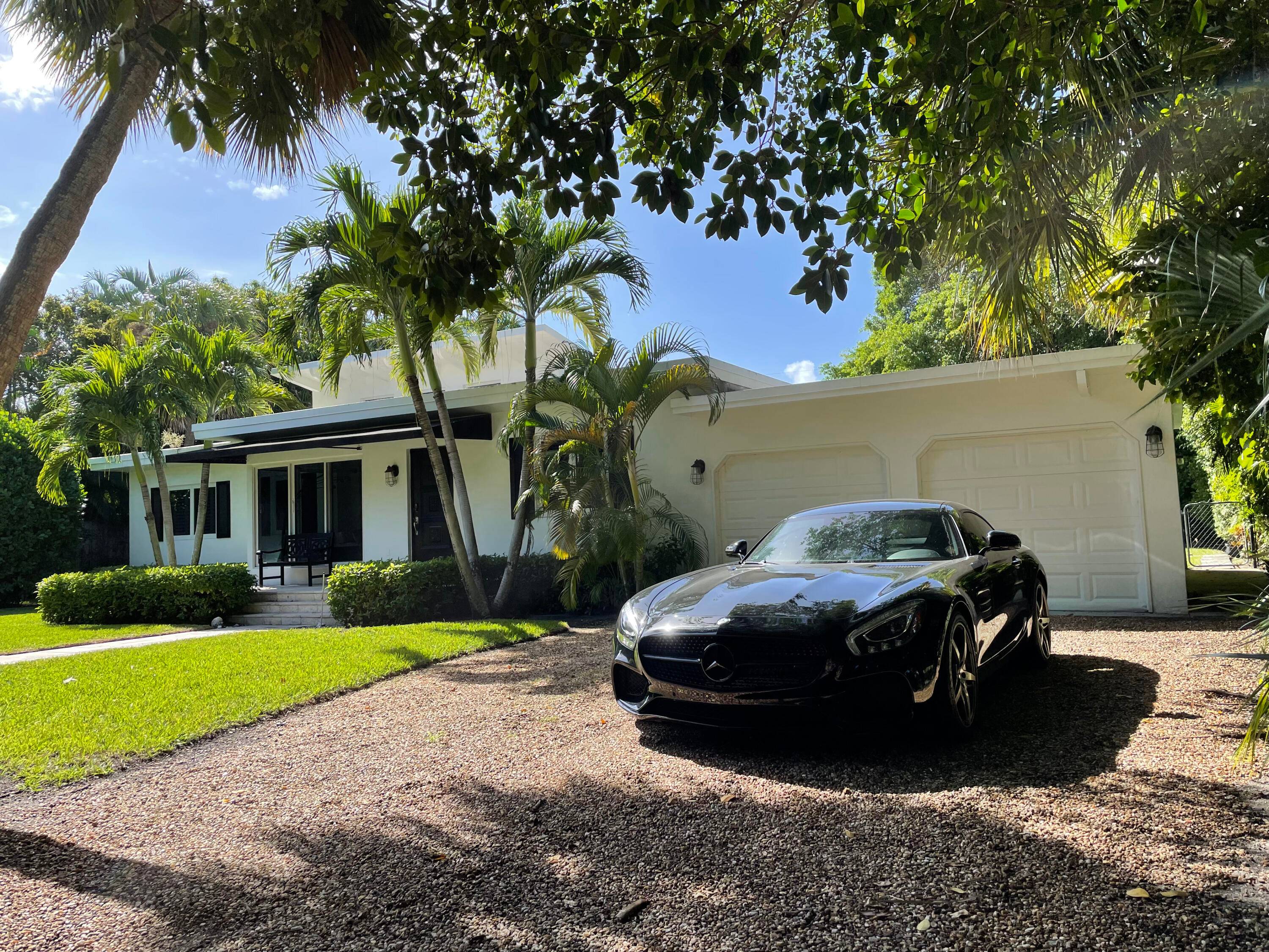 Tucked away upon a rare, lushly landscaped oversized 15, 500 sq ft private lot on Hypoluxo Island sits this Mid Century Modern gem.