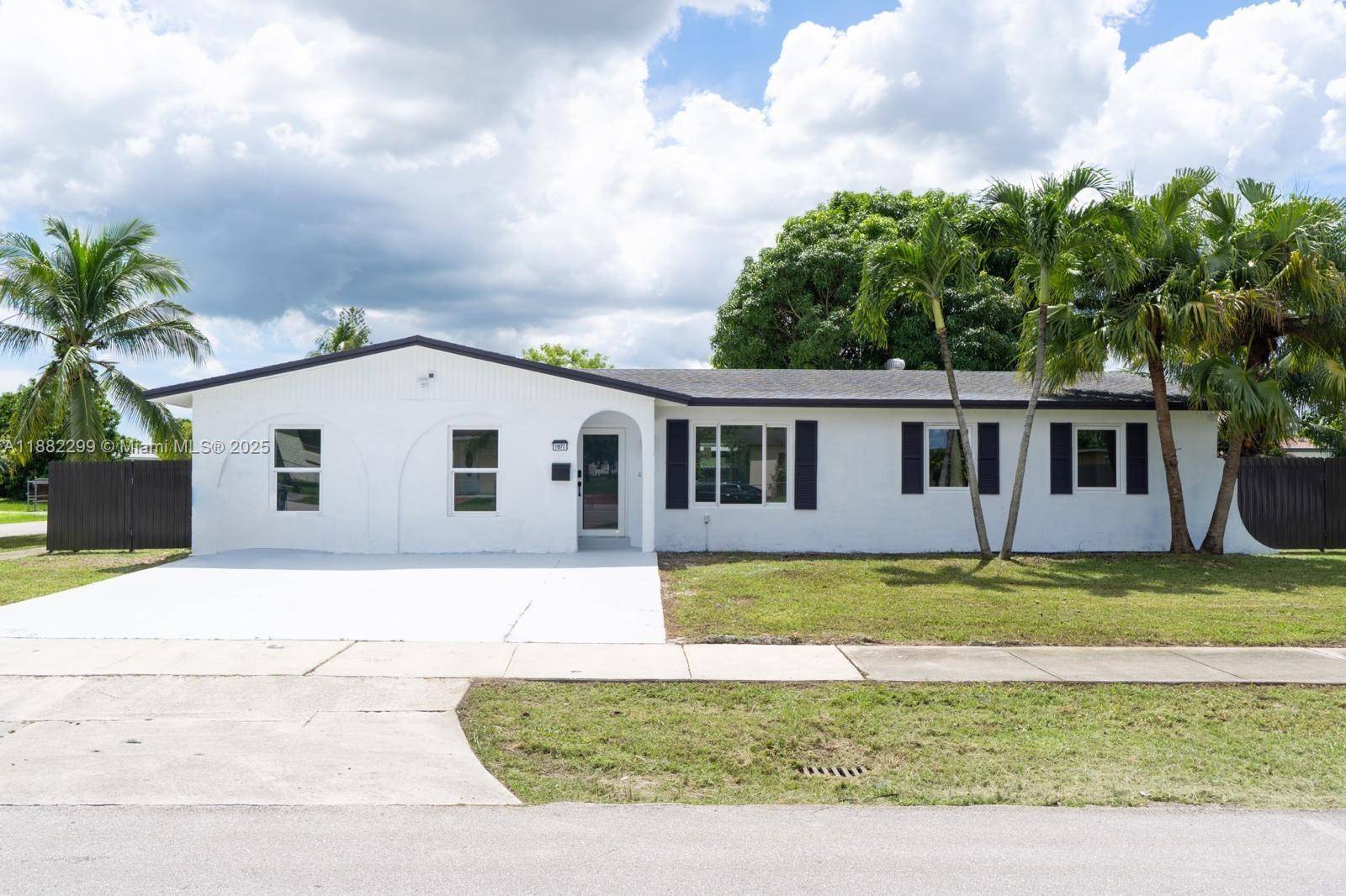 Exquisite renovated home featuring hurricane impact windows, new appliances, and full porcelain floors.