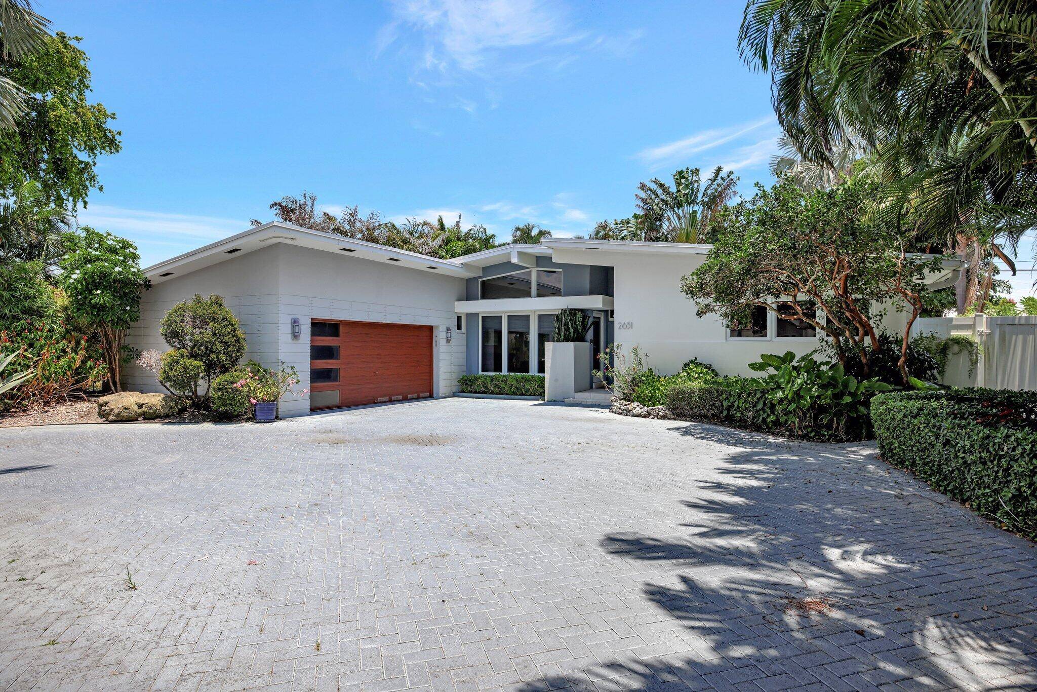 Nestled in the sought after Harbor Village community of Pompano Beach this charming home beckons with it's elegance and prime location just across the street from the intercoastal.