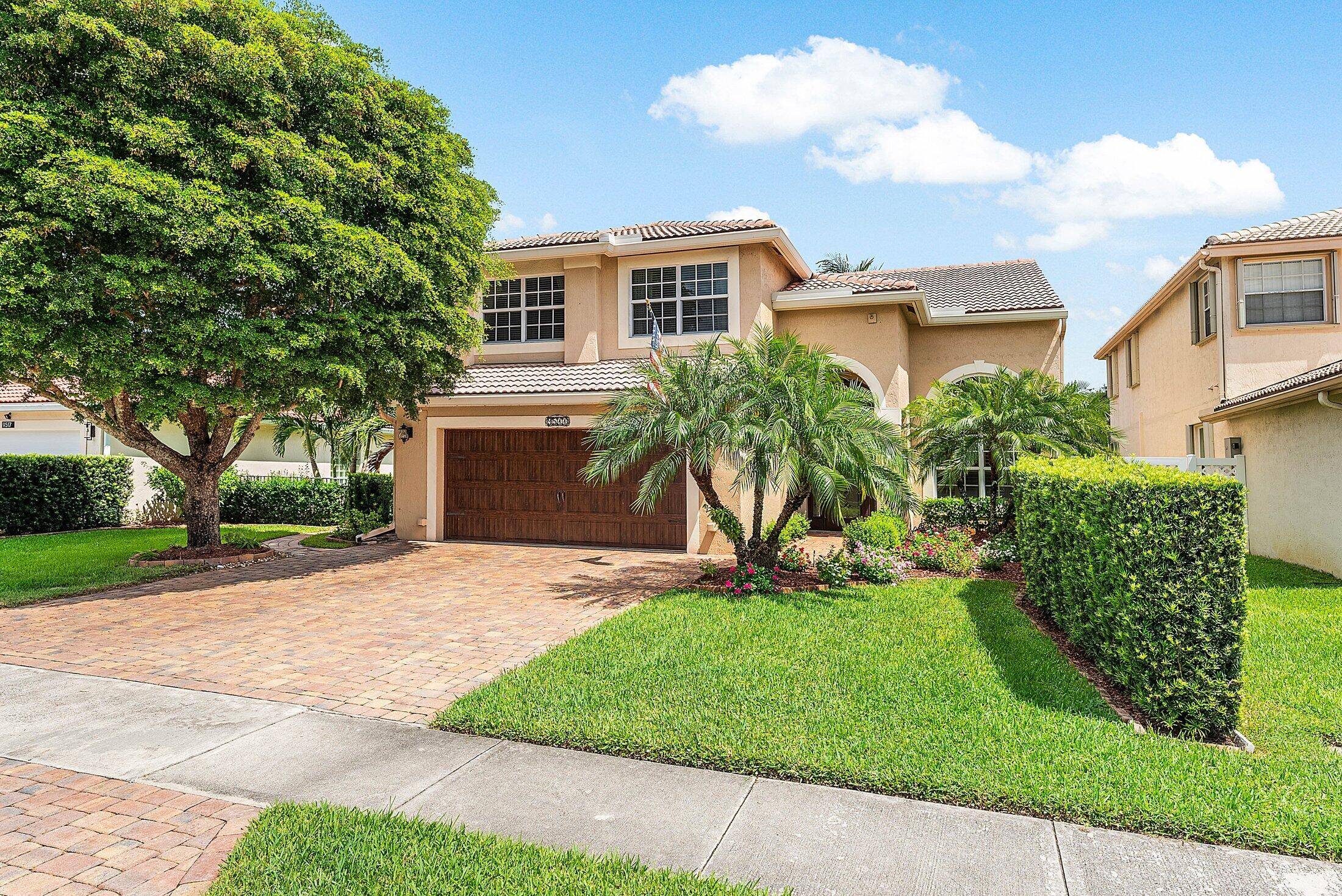 Set on the widest lakefront lot in the community, this exceptional 4 bedroom, 3.