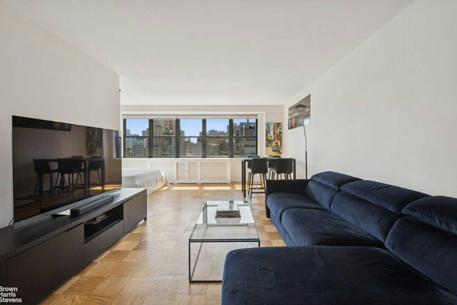 Sunrise to Moonlight Your Elevated Oasis Awaits Move right into this bright, high floor, oversized alcove studio with sweeping open east facing city views.
