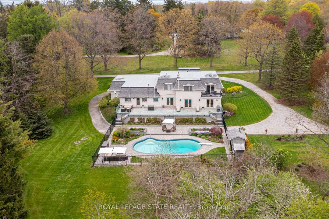 Set on nearly 1. 7 acres with incredible panoramic views, this stately all brick home offers a rare opportunity to enjoy resort style living surrounded by privacy, mature trees, and ...