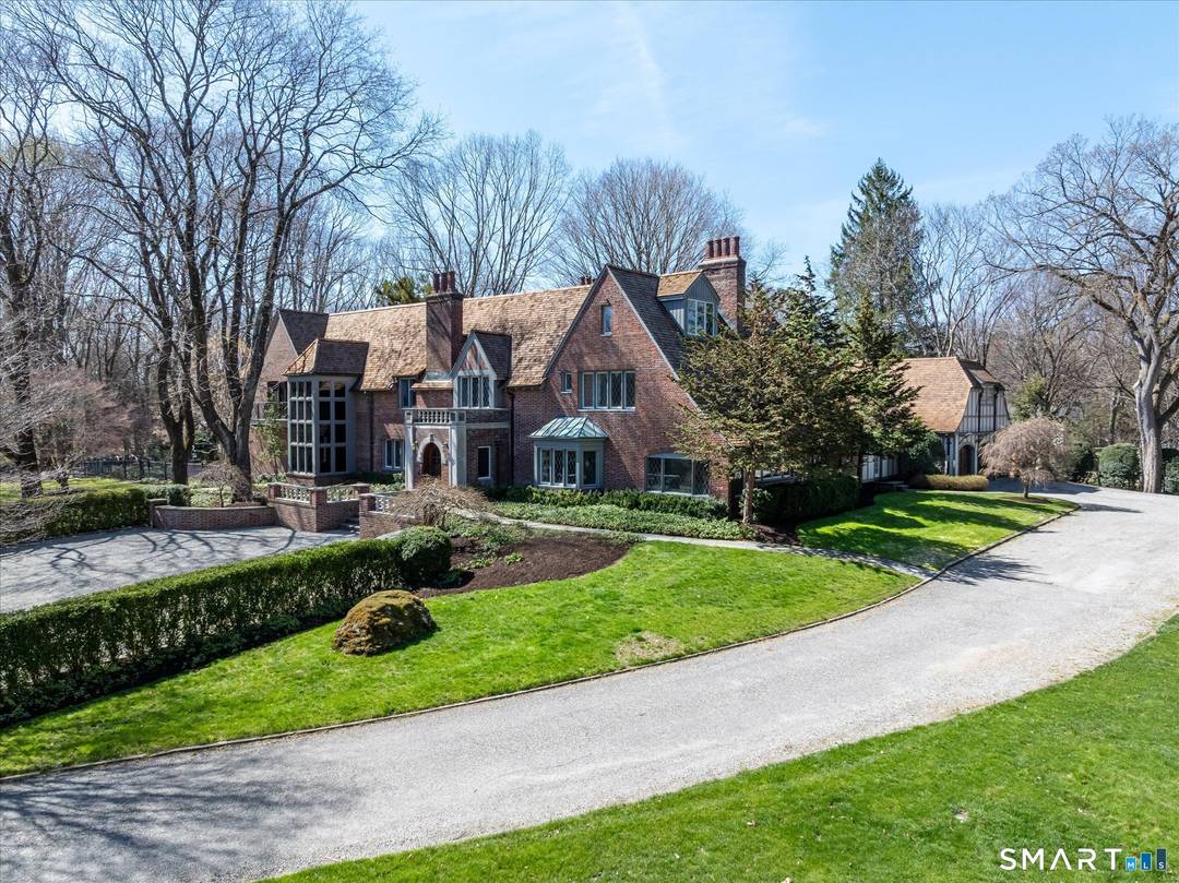 Rock Ledge, a private estate in Weston, is set on nearly five acres surrounded by protected land at the end of a cherry tree lined private drive.