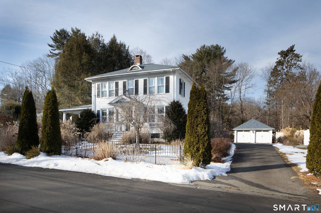 This early 1900's Colonial is filled with warmth, character, and outdoor charm.