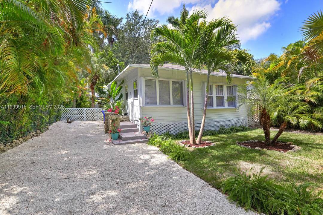 Charming 1925 Key West style cottage tucked beneath a lush tropical canopy in Coconut Grove.