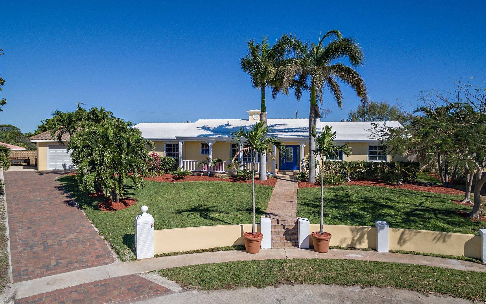 This exceptional residence, situated on the highest and most private lot within Juno Isles, offers unparalleled tranquility and proximity to the beach.