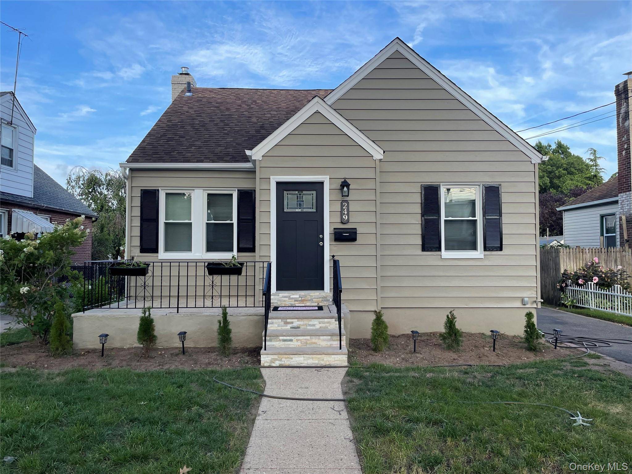 THIS BEAUTIFUL RENOVATED HOME SITS ON A QUIET TREE LINED STREET IN THE HEART OF FRANKLIN SQUARE !