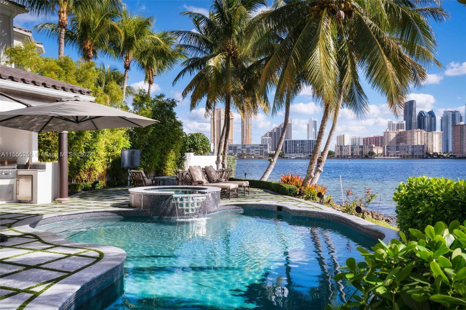 Own a former celebrity bayfront three story Mediterranean estate in the prestigious gated community of Island Estates.
