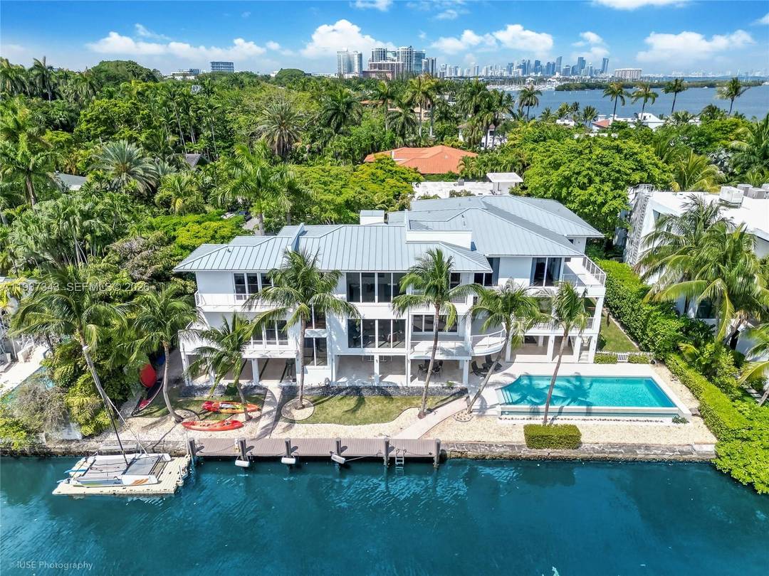 A private tropical oasis waterfront estate with 150 FT of water frontage in the exclusive gated Four Way Lodge Estates, Coconut Grove.