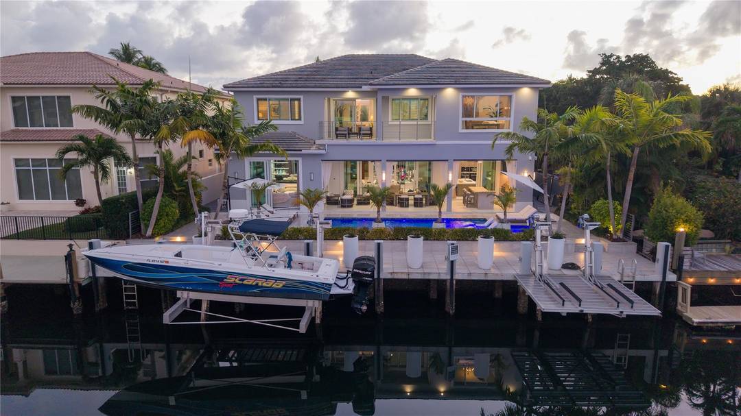 Gated, Coastal Contemporary Deepwater Estate sited on 75' of waterfrontage with wide, spell binding views of Lake Placid on Lighthouse Point s prestigious Intracoastal Drive.