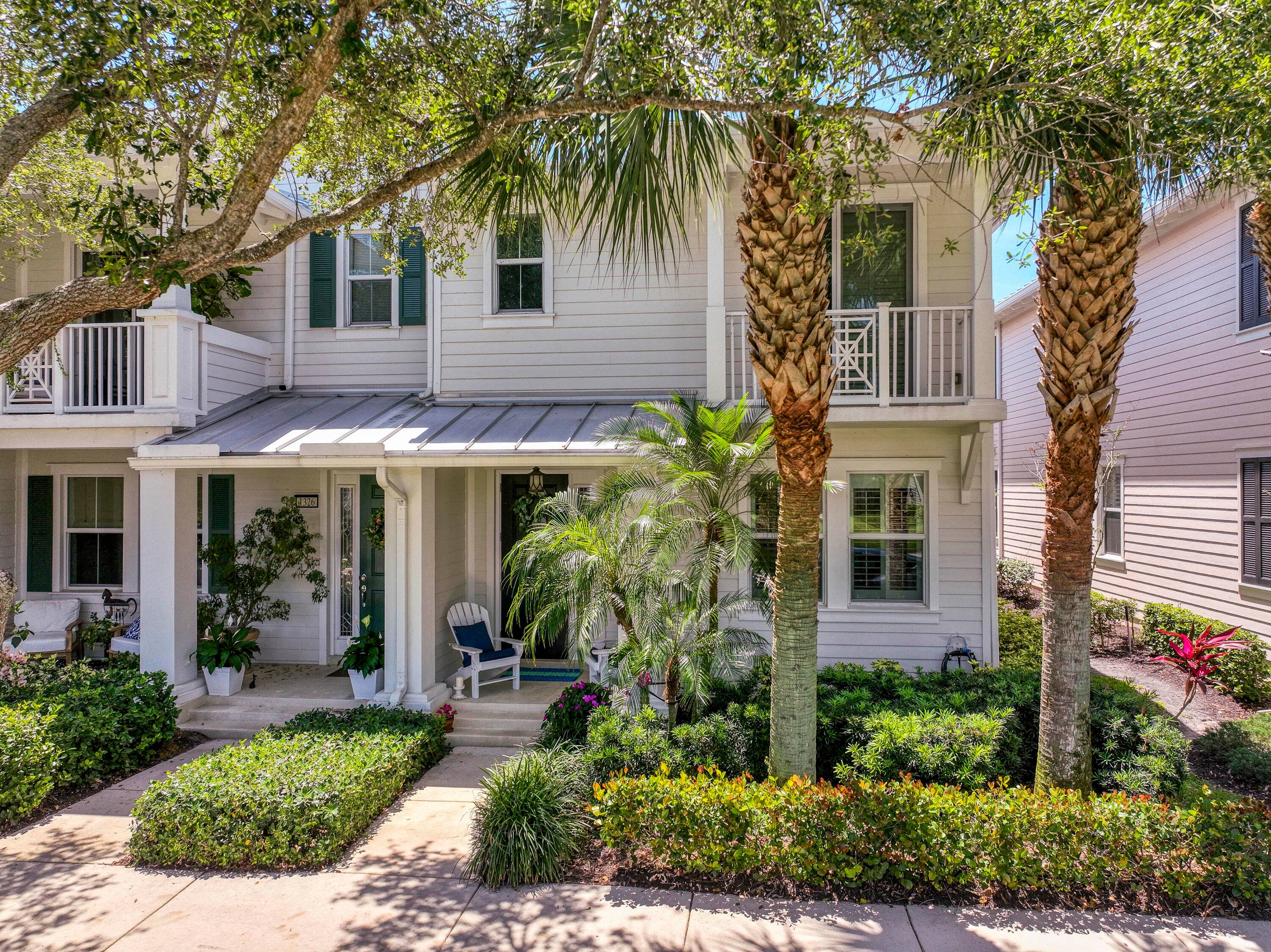 Located on a picturesque tree lined street in the heart of Jupiter, this 3 bedroom, 2.