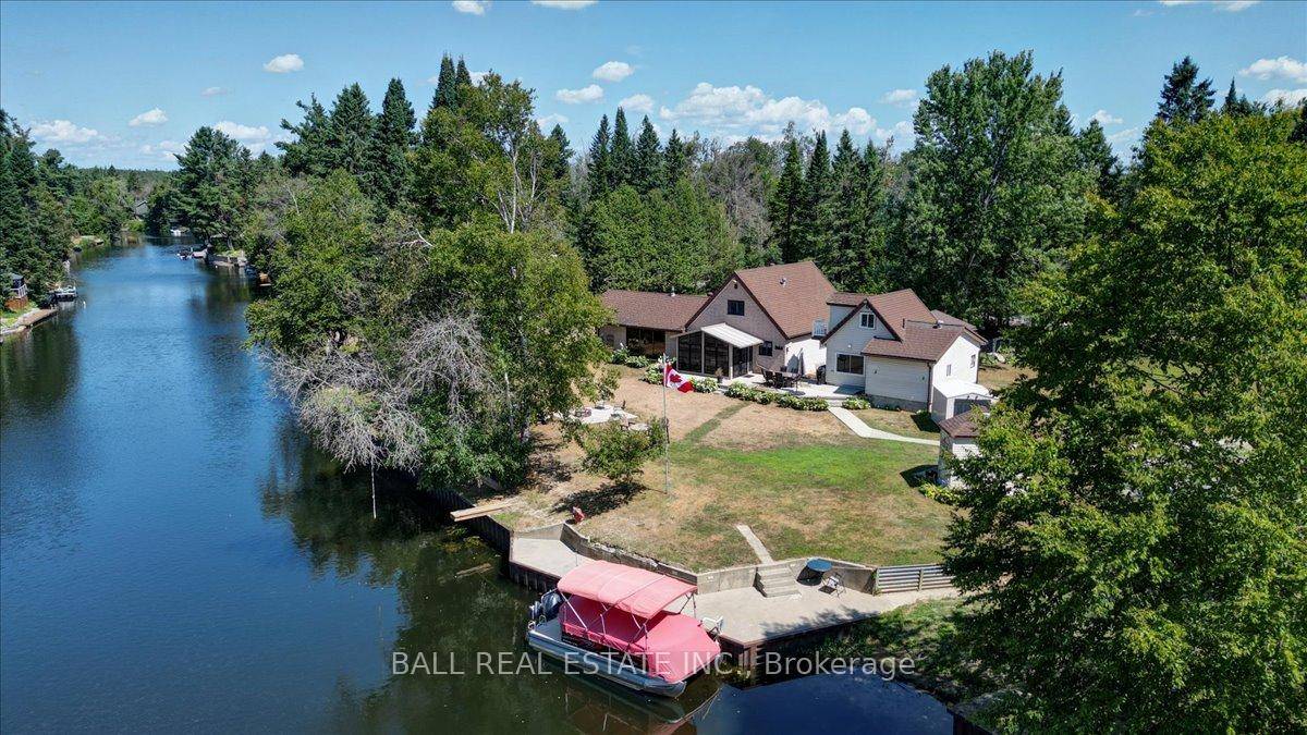 Burnt River home or cottage on a large lot, with a three bedroom secondary residence and a large shop.