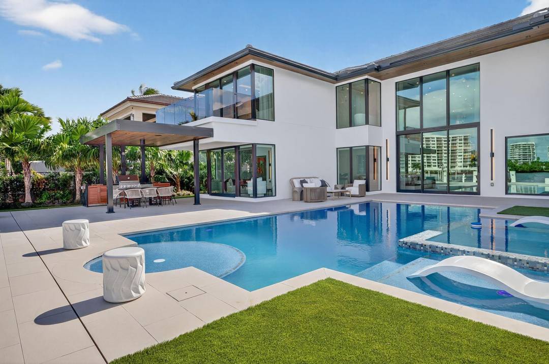 Newly completed custom estate with unobstructed river to Intracoastal panoramas in Seven Isles' most coveted location.