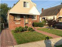 Live mortgage free 2 family home with private driveway that fits 3 cars and garage and basement with outside entrance porch, near transportation