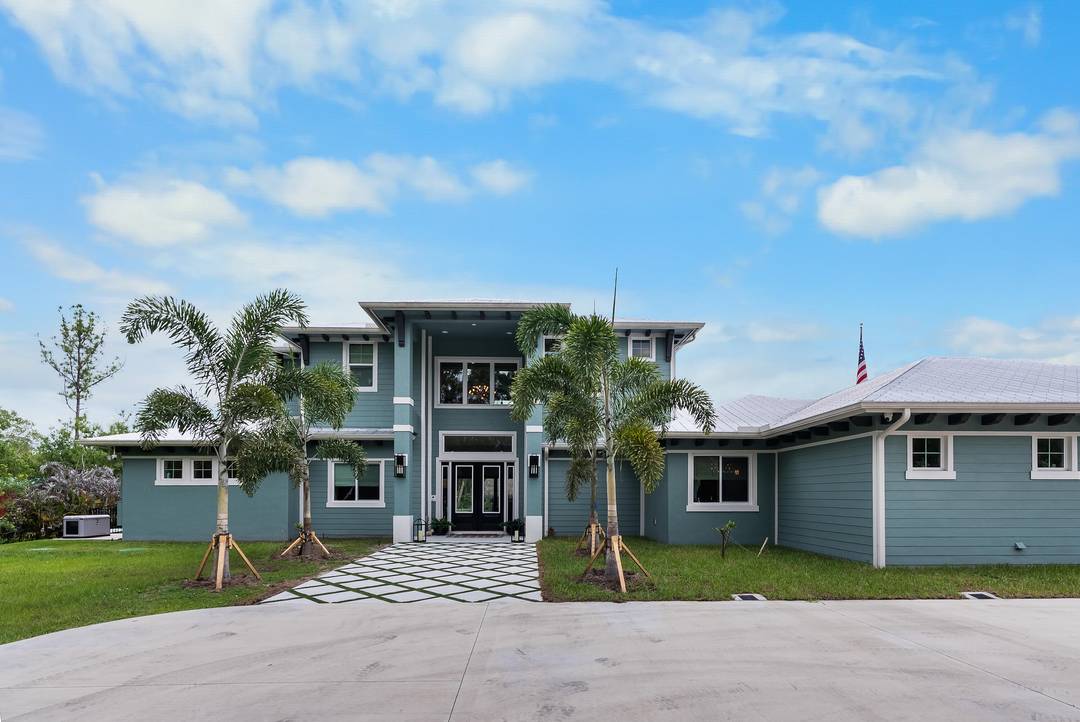 Behind a private electronic gate in prestigious Palm City Farms lies this extraordinary near new luxury compound built to exceptional standards with full concrete block construction including the second floor.