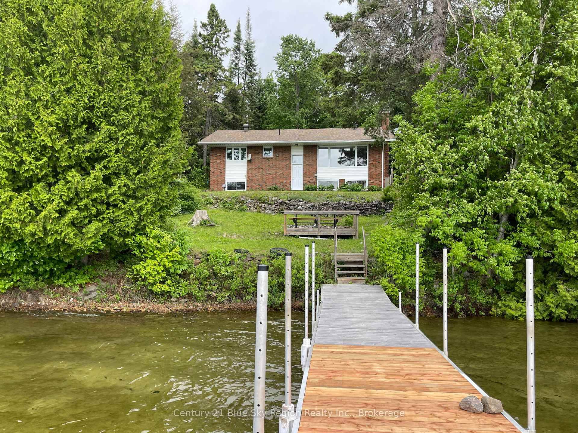 This charming one owner 3 bedroom, 2 bathroom brick bungalow offers the perfect blend of comfort, character, and an unbeatable waterfront setting.