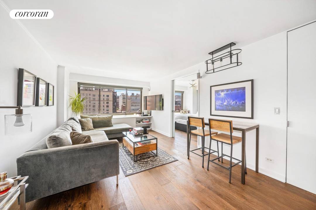 Experience southern light and sweeping city views from this high floor one bedroom home at 201 West 21st Street, Apartment 12J, in the heart of Chelsea.