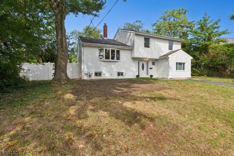 Stunning East facing renovated split level home featuring 4 spacious bedrooms and 2.