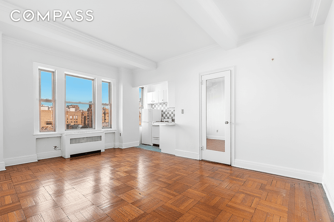 Soaring beamed ceilings over 9 feet high fill this expansive studio at 24 Fifth Avenue, Apt.