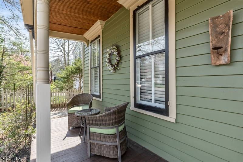 Charming historic Colonial with a rocking chair Front Porch blending old world architectural character with numerous modern updates consists of updated eat in Kitchen with granite counters, wood cabinetry.