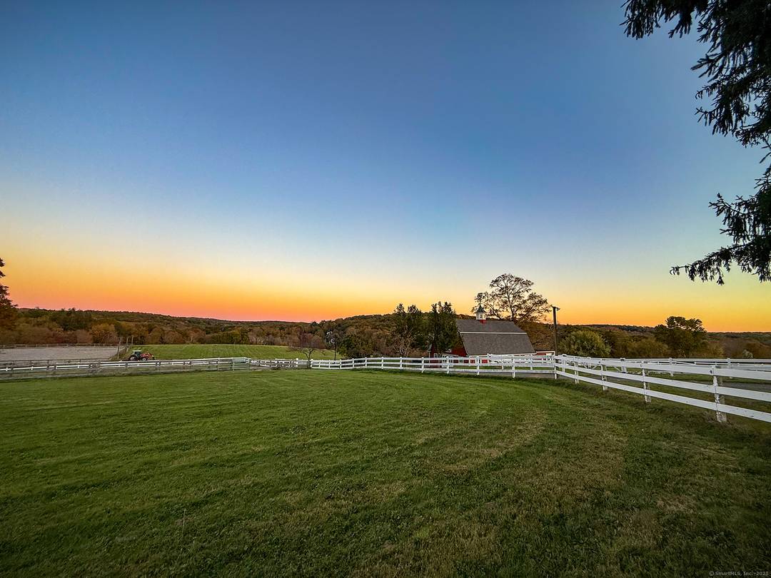 Discover refined country living in this remarkable Woodbury estate set on 33.