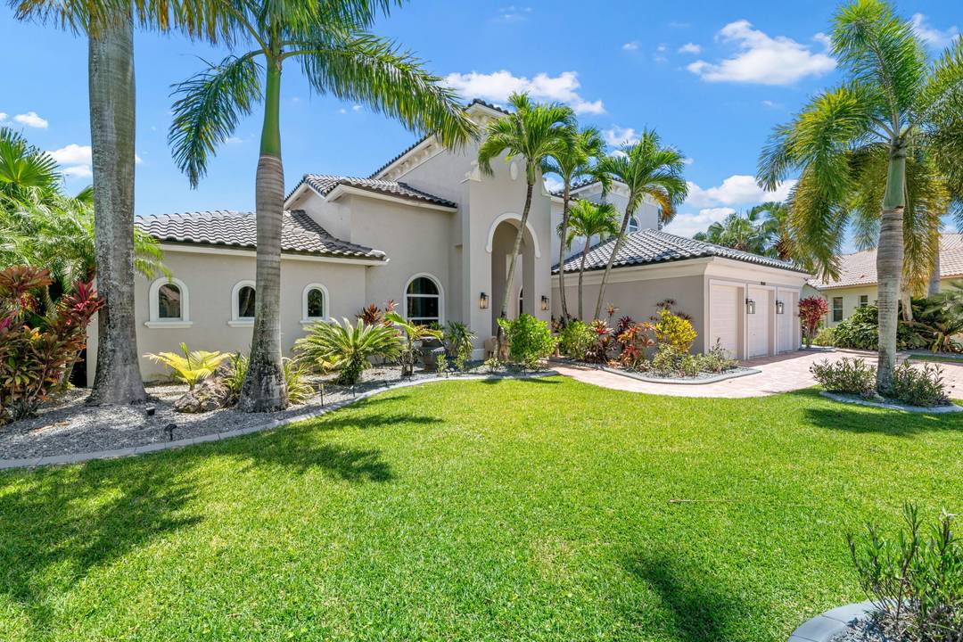 . Located in the prestigious Estates of The Isles at Wellington, this fully remodeled lakefront residence offers 7 bedrooms and 5.