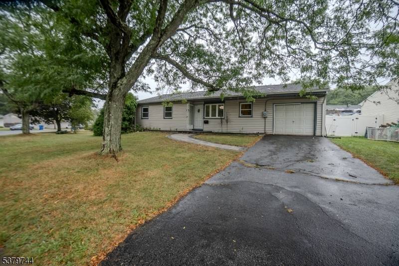 Immaculately maintained and move in ready residence showcasing freshly refinished hardwood floors throughout.