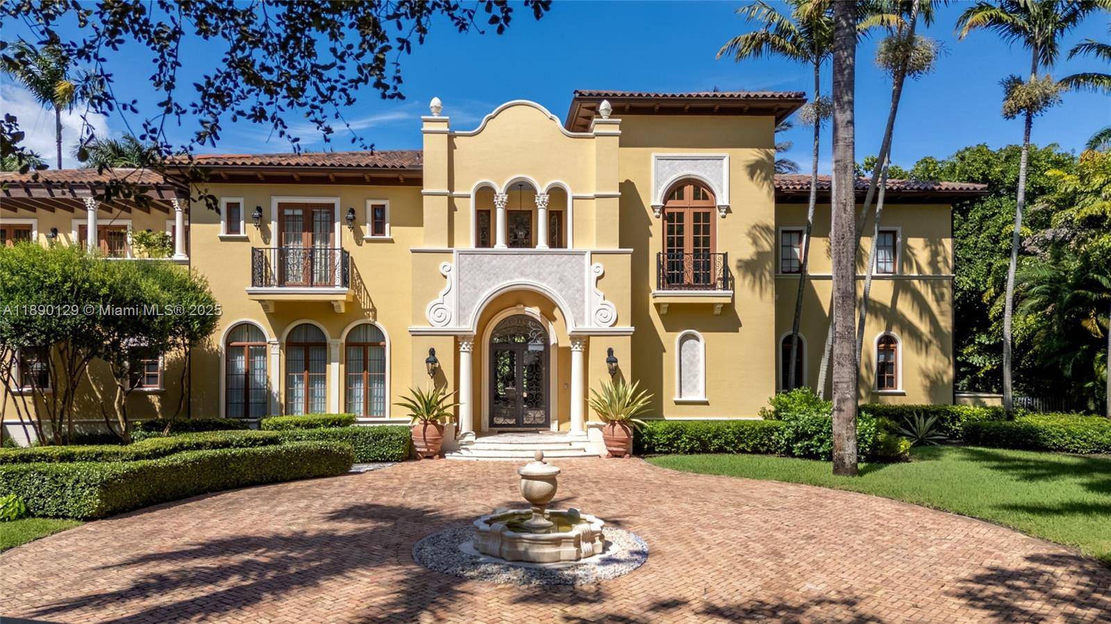 Step into this stunning Pinecrest estate, nestled on nearly an acre of lush greenery.