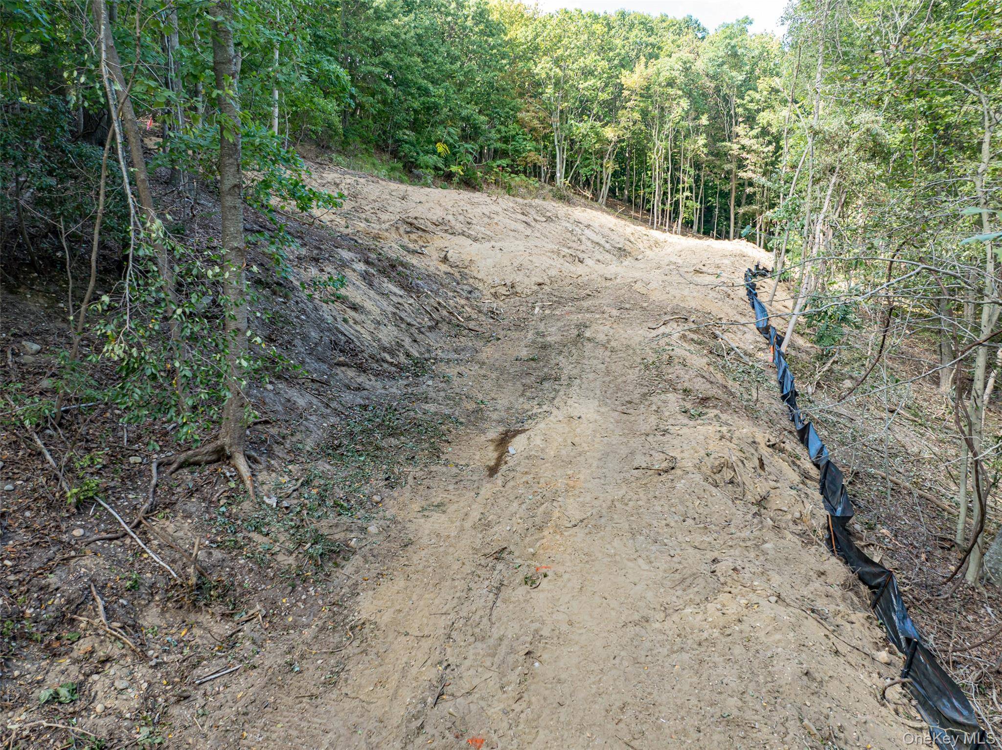 Desirable Vacant Lot for Sale Ready for Construction Nestled on a cleared hillside, over looking a natural easement buffer, this.