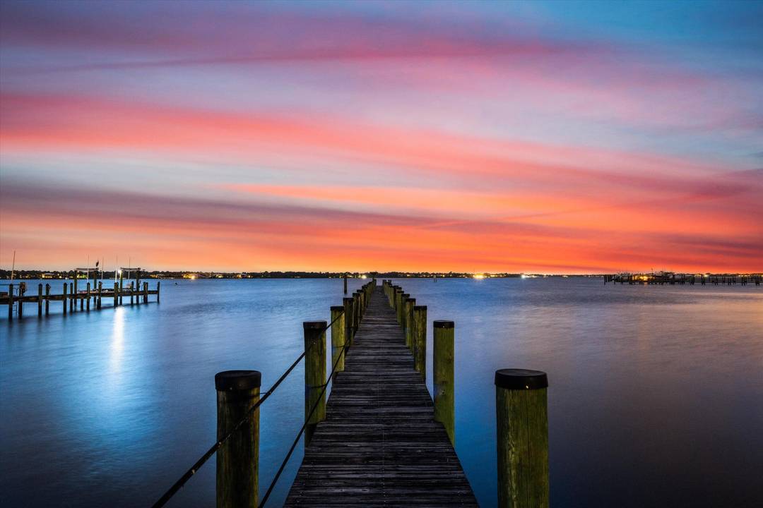 Spanning more than 200 feet of protected shoreline, this rare double riverfront estate offers an exceptional balance of privacy, scale, and uninterrupted St.