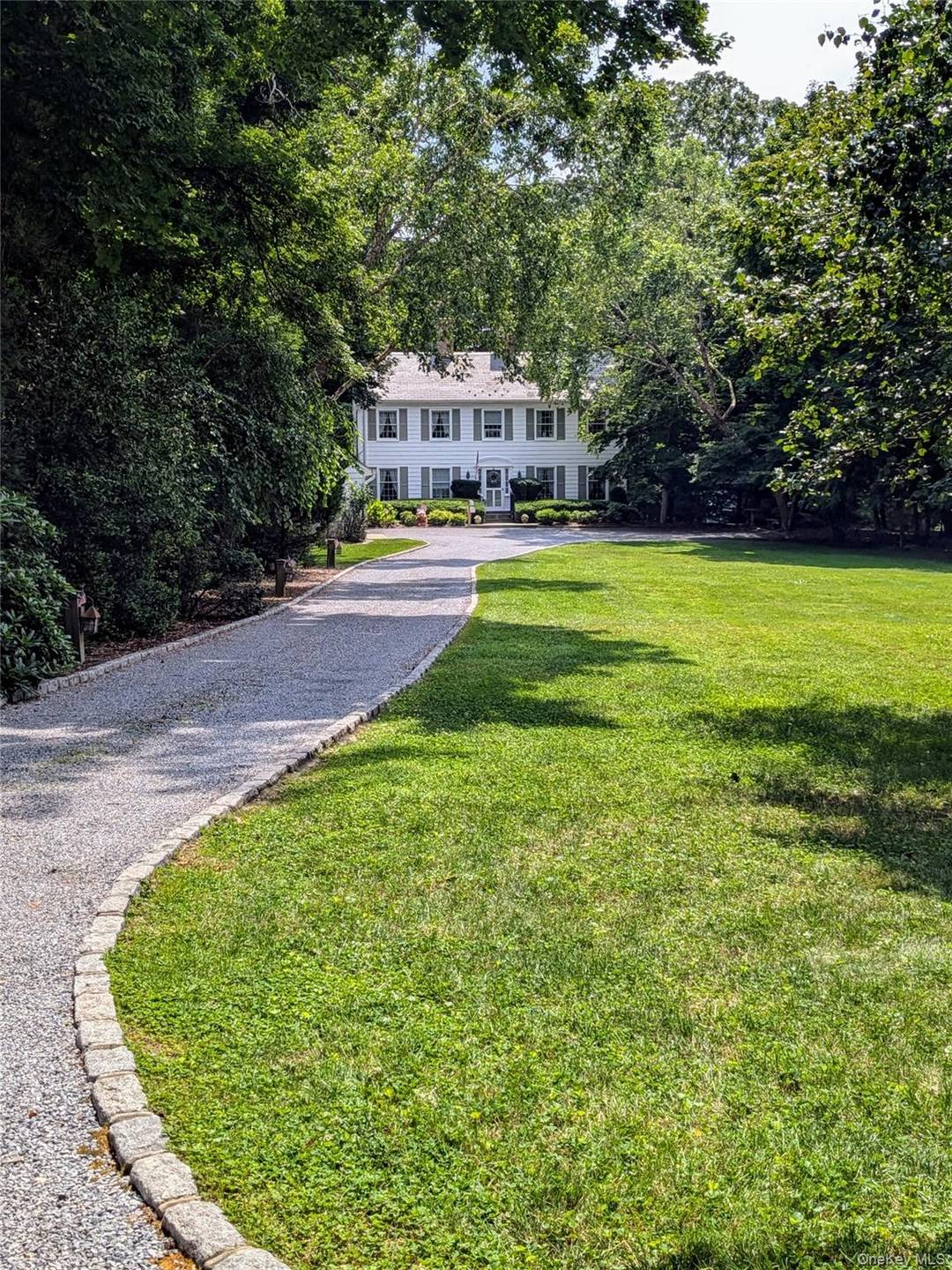 Classic colonial home on Conscience Bay with deepwater dock and beach frontage.