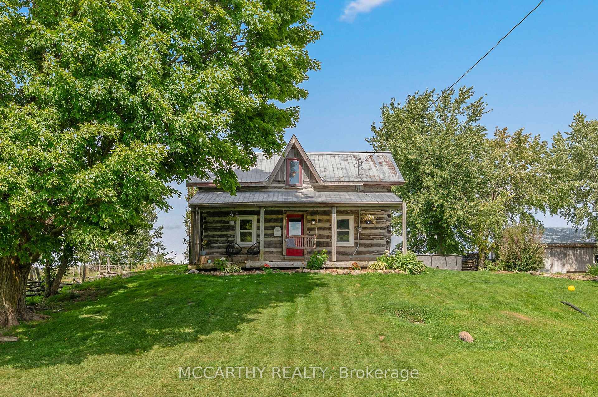 Step into the dream of rural living with this captivating log home set on 9.