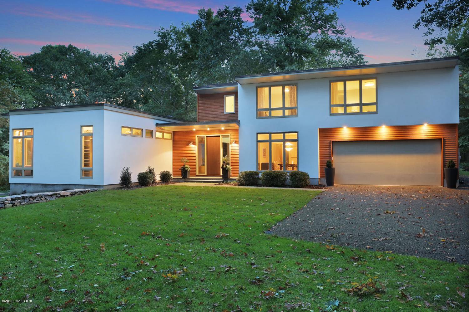 Refined and modern home with glass walls, open spaces and sophisticated aesthetic.