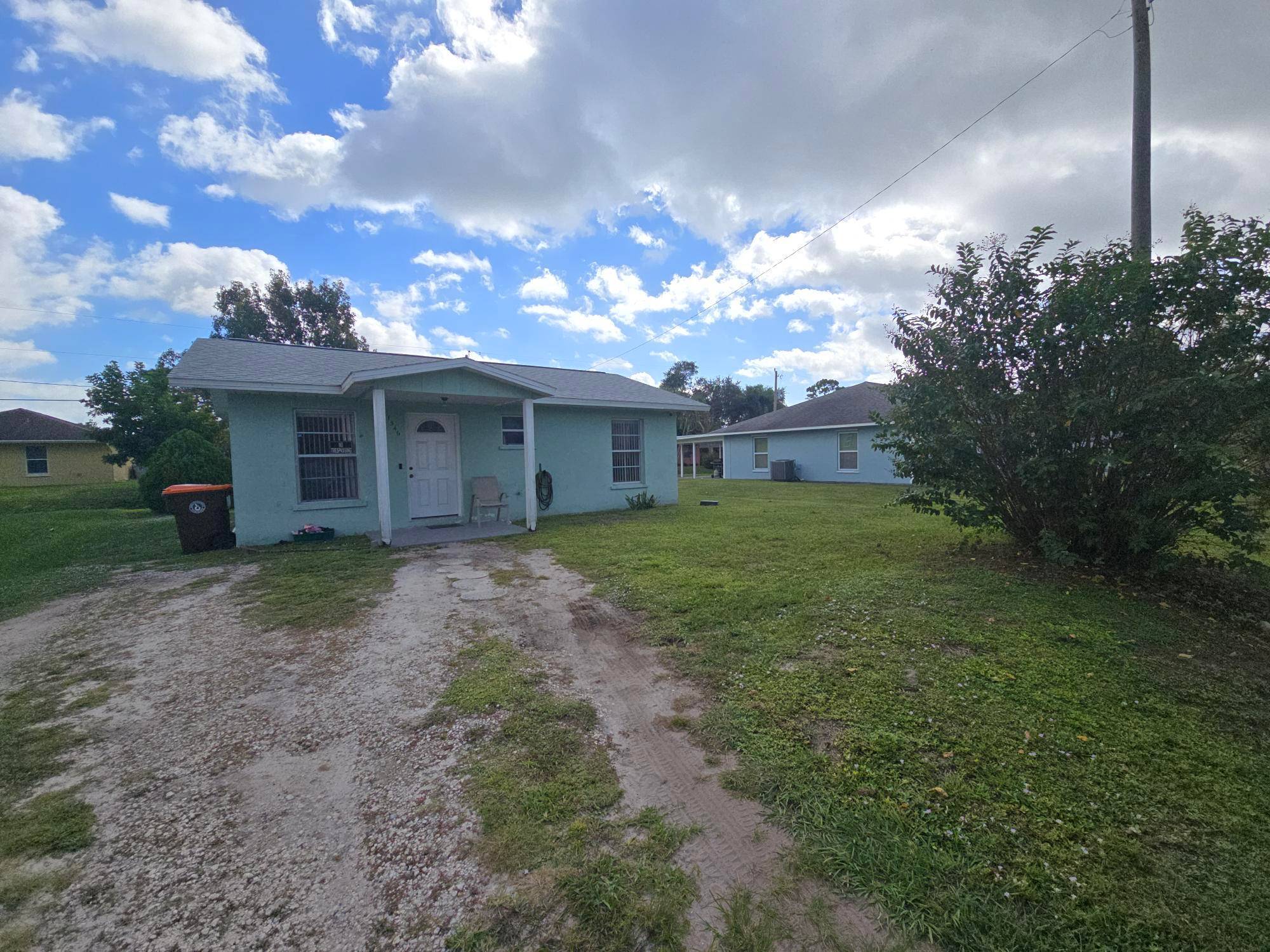 Charming 2 bedroom, 1 bath single family home featuring a versatile bonus room at the rear, perfect for an office, playroom, or guest space.