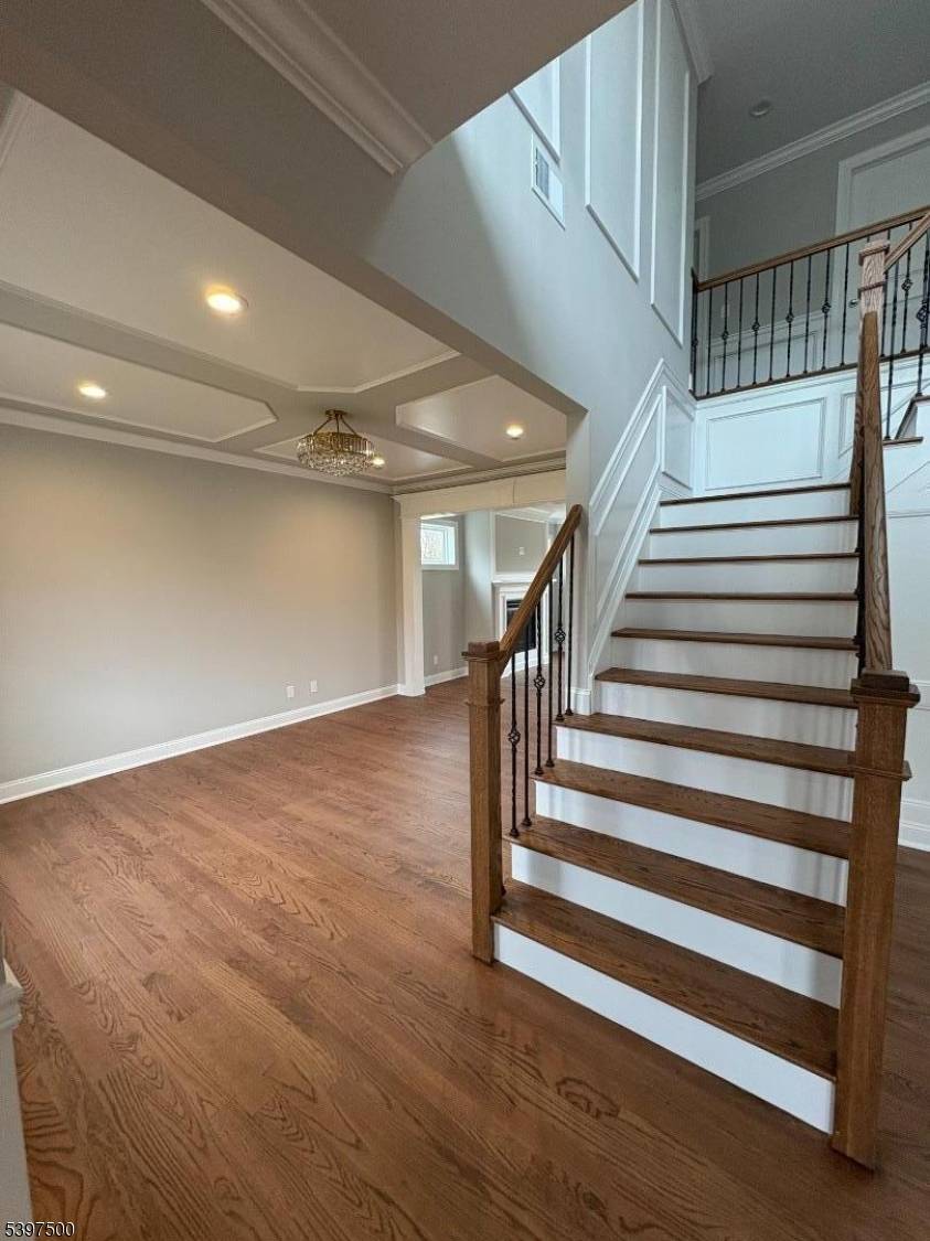Brand new construction with many upgrades quartz countertops, custom cabinets, moldings, extra high hats, gas fireplace, large center island, hardwood floors throughout, walk up attic stairs, composite deck and generous ...