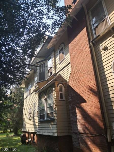 This charming late 19th century Victorian home built in the Queen Anne Architectural Style, located in the Van Wycks Historic District, has been converted into a spacious multifamily property.