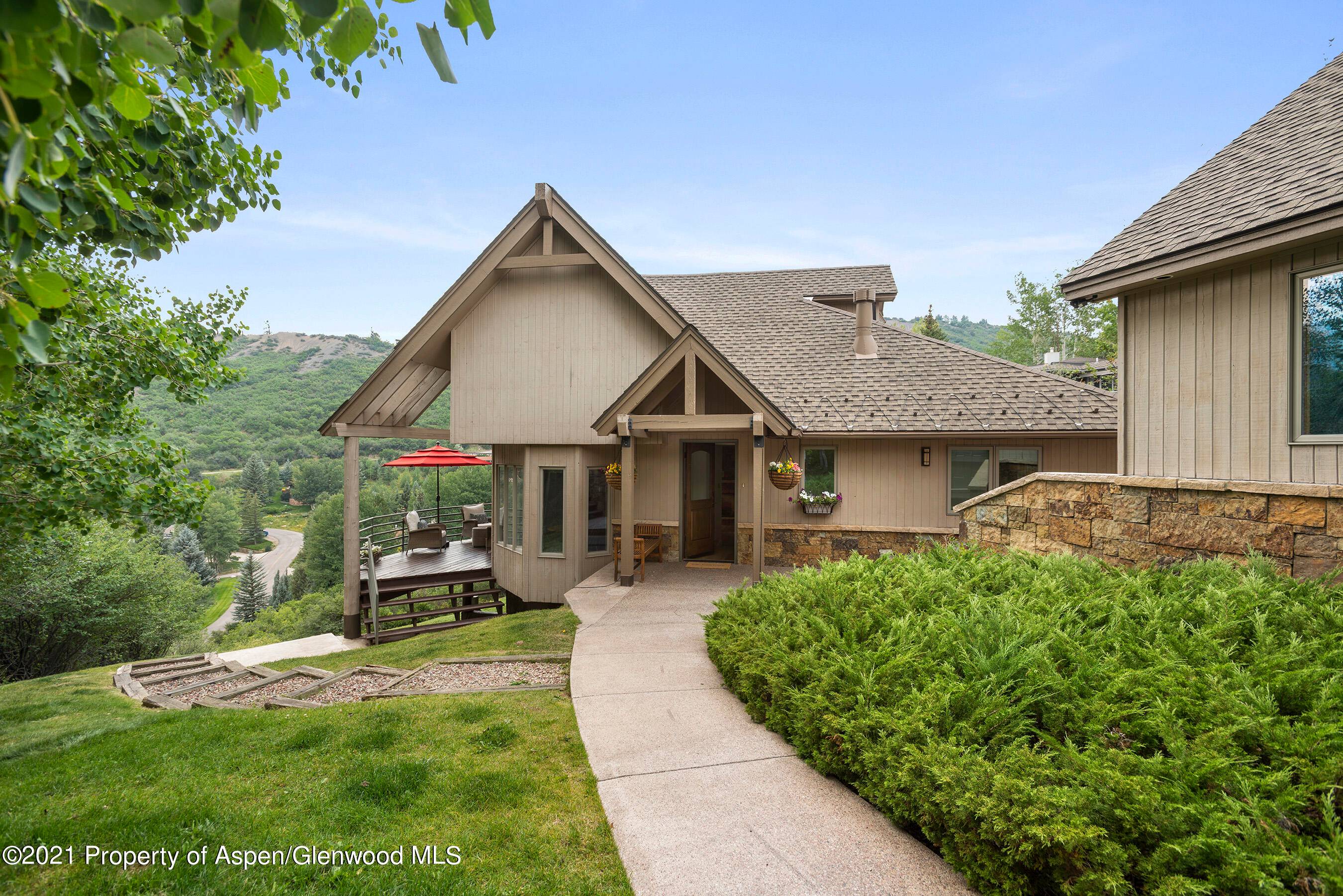 9 Lemond Circle is on a private secluded bluff with incredible views of the Snowmass ski area captured by huge windows and redwood decks.