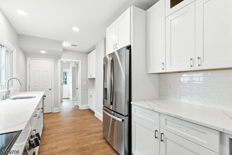 Enjoy a beautifully updated kitchen with quartz countertops, stainless steel appliances, and plenty of space to cook and gather.