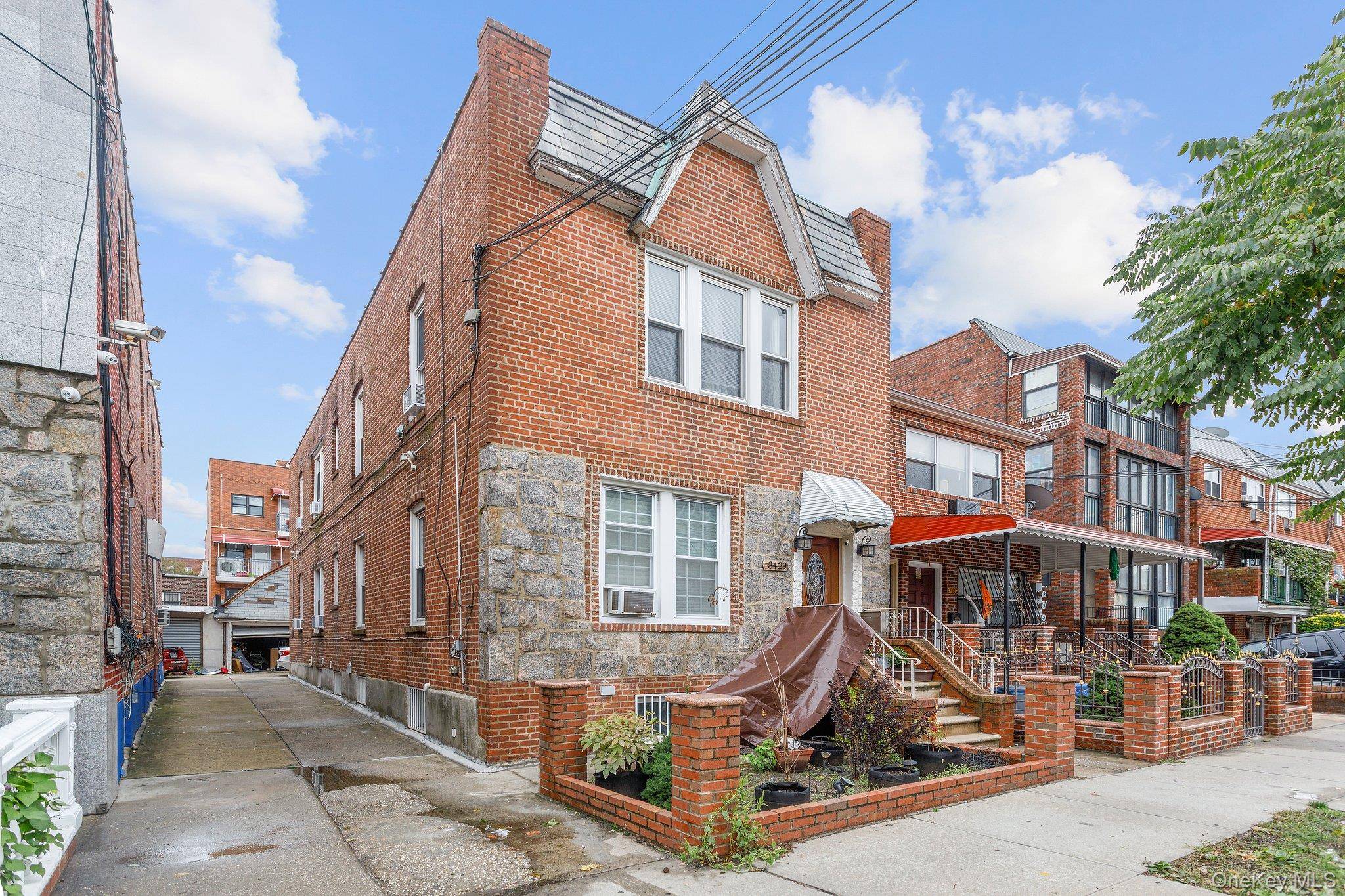 Solid brick two family house featuring 2 bedrooms, a living room, and an eat in kitchen in each apartment.