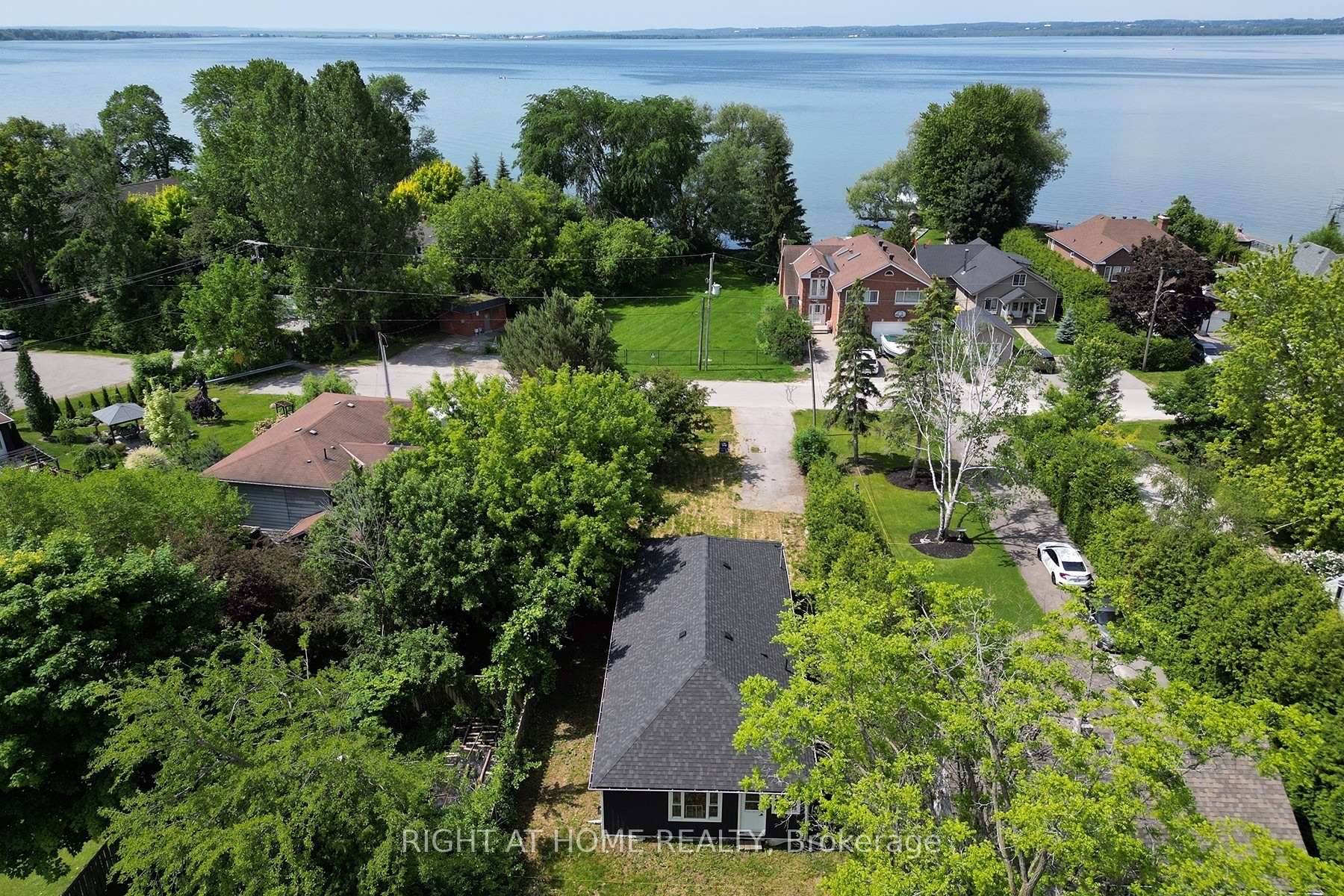 BEAUTIFUL BUILDING LOT WITH EXISTING OLD COTTAGE OVERLOOKING GREEN SPACE AND THE LAKE NOT LIVABLE.