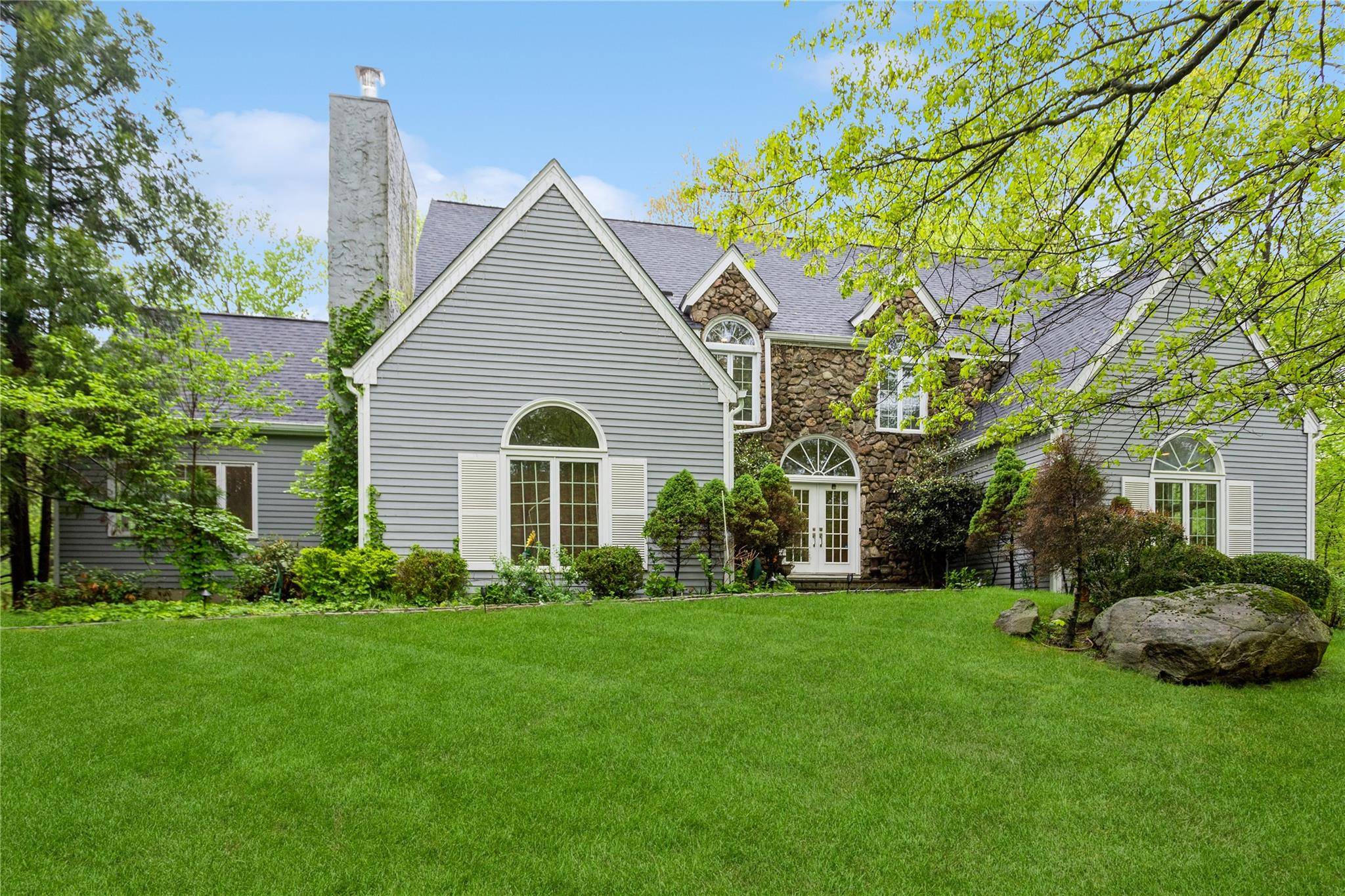 Elegantly updated Modern Colonial with majestic curb appeal on a quiet country cul de sac.