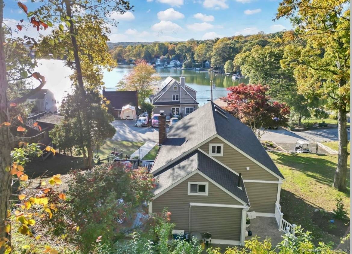 Welcome to this beautiful year round remodeled lake home offering breathtaking views overlooking the shimmering waters of Lake Pocotopaug.