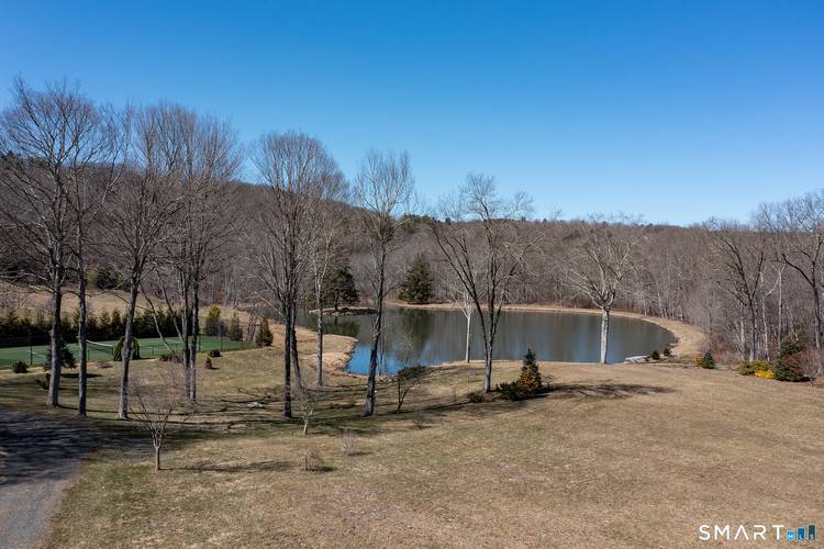 Stunning estate property located on coveted Calhoun Street close to Washington Depot featuring large swimming pond hillside views.