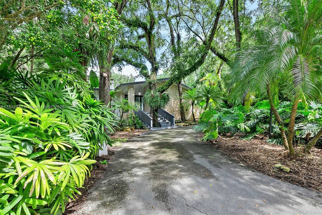 Beautiful residence in the heart of Pinecrest, set on a spacious corner lot with lush landscaping.